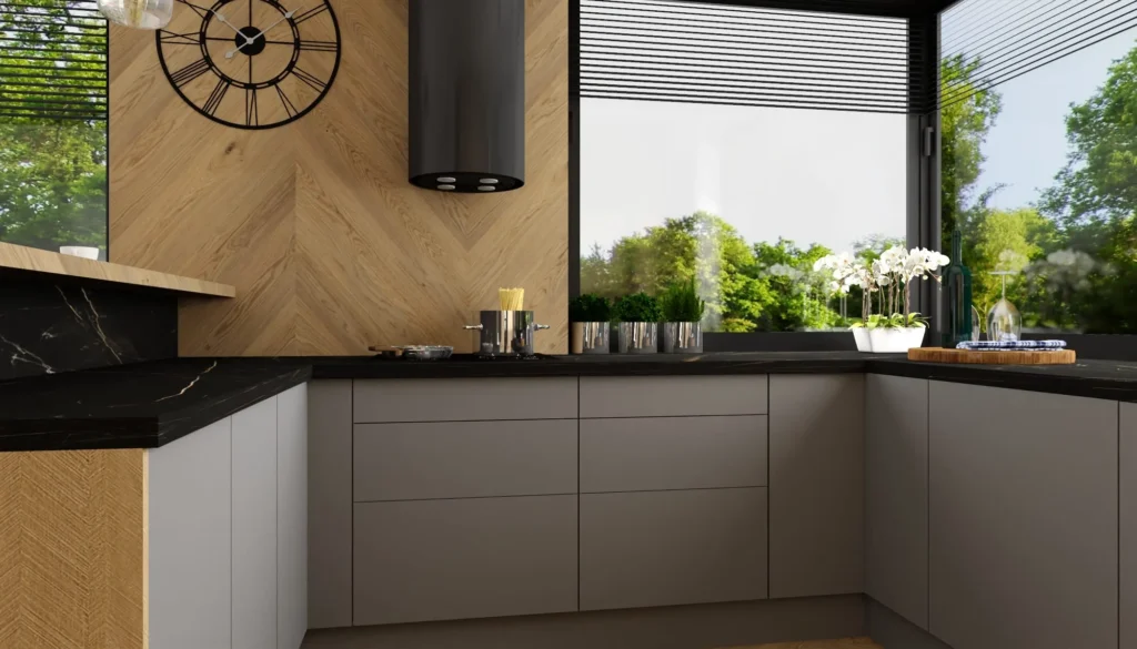 Aranżacje kuchni nowoczesnych – szare matowe fronty, czarny blat, drewniany panel w jodełkę oraz duże narożne okno z widokiem na ogród